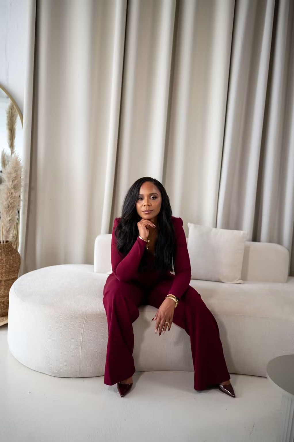Shanakay Millington seated in burgundy at the Boss Up Live branding shoot